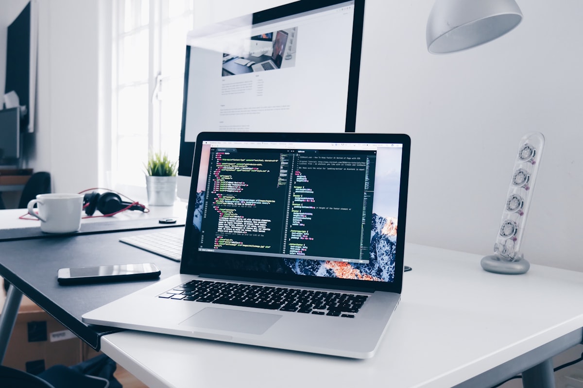 Indie game developer workspace with interface mockups