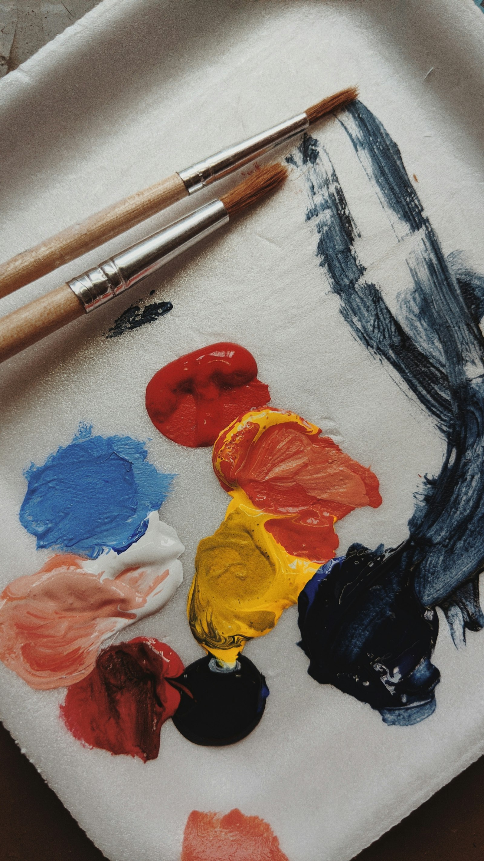 Paint tubes in vibrant colors arranged neatly